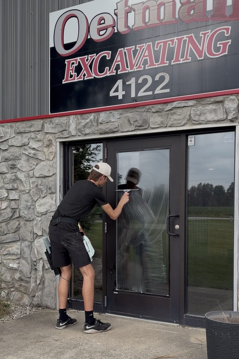 Team Gleam cleaning a commercial storefront door